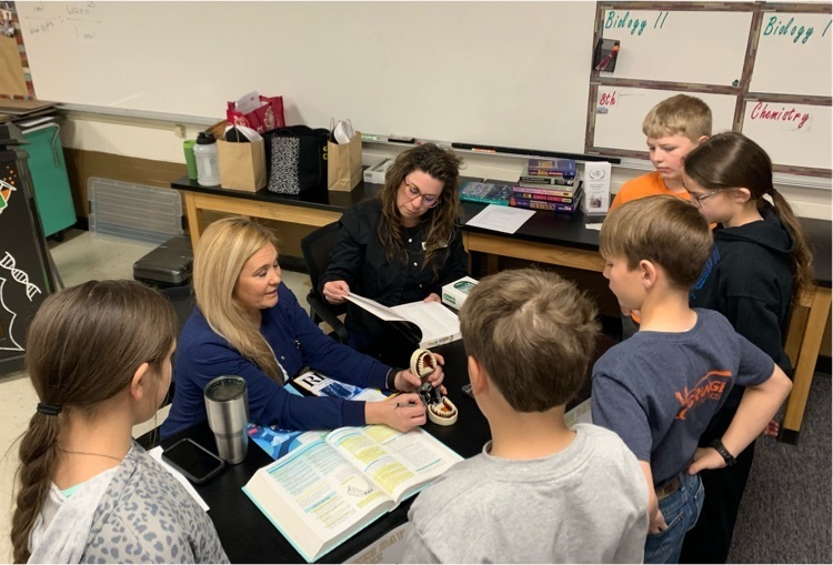 Lori Bayless and Shane Suthers talking to several students about their career in dentistry and proper teeth cleaning. 🦷 