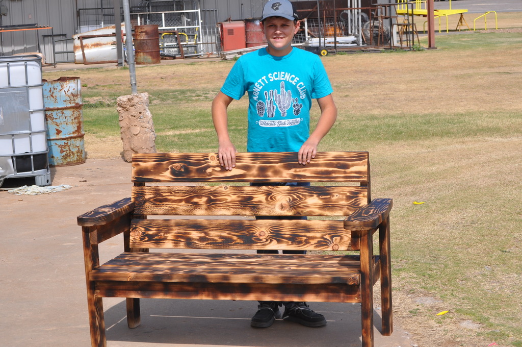Monty Wilson with his garden bench he made in Woodshop 