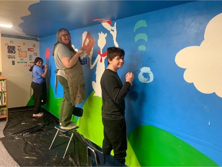 Mrs. Sally Wheeler and her art class painting their Dr. Suess mural. 